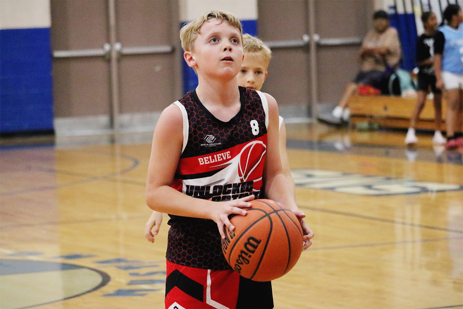 A picture of a player shooting a free throw in Unlocked Potential's flag elite fall youth basketball league
