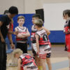 A picture of a coach, coaching a youth basketball team in Unlocked Potential's flag elite fall youth basketball league