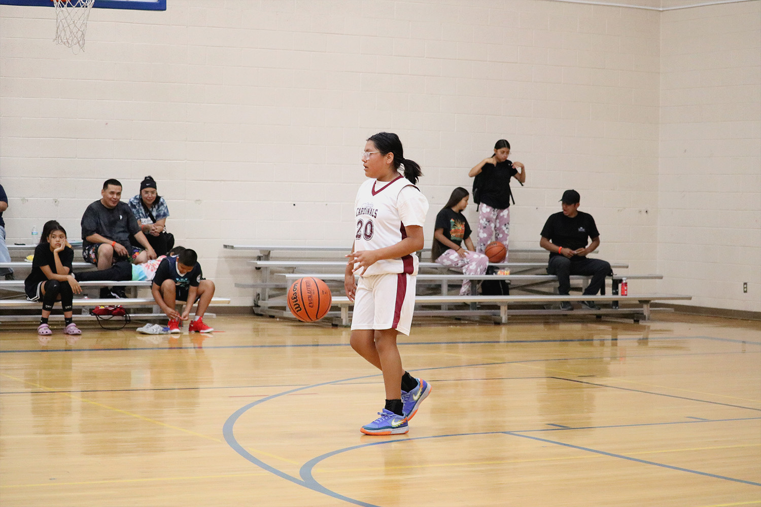 A picture of a player dribbling a basketball up court in Unlocked Potential's flag elite fall youth basketball league