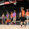 A picture of kids preparing for a rebound playing at the Unlocked Potential winter league championship at the Phoenix Suns mortgage matchup arena.