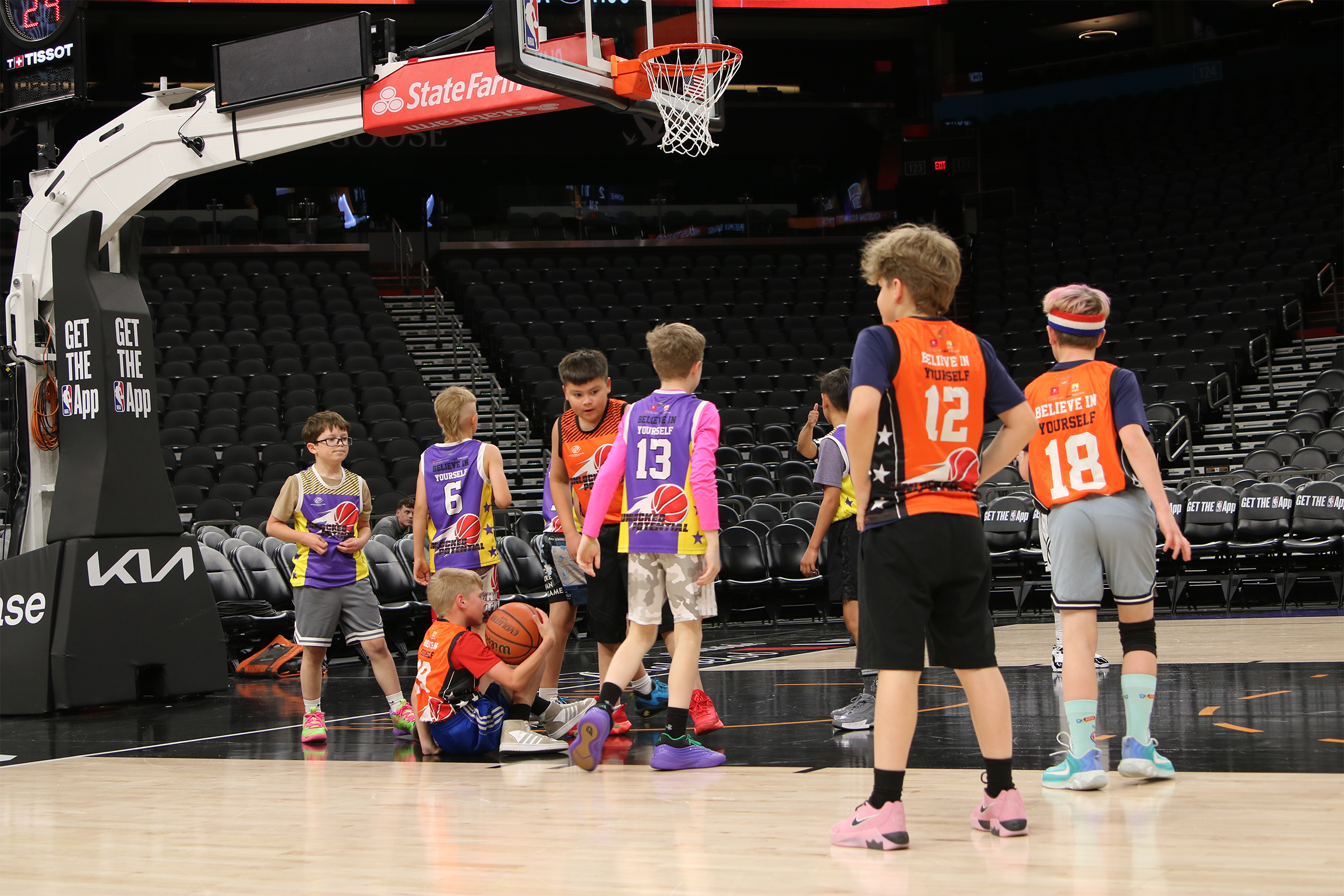 A picture of kids preparing for a rebound playing at the Unlocked Potential winter league championship at the Phoenix Suns mortgage matchup arena.
