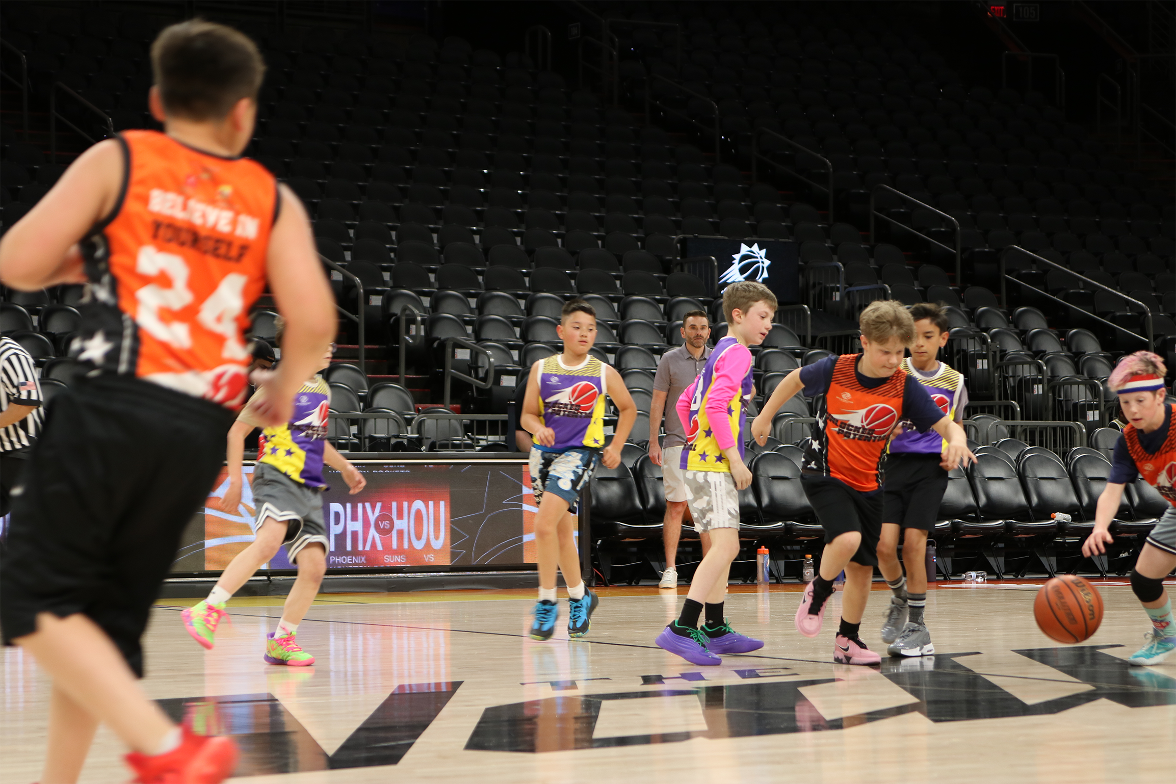 A picture of kids going on a fast break playing at the Unlocked Potential winter league championship.