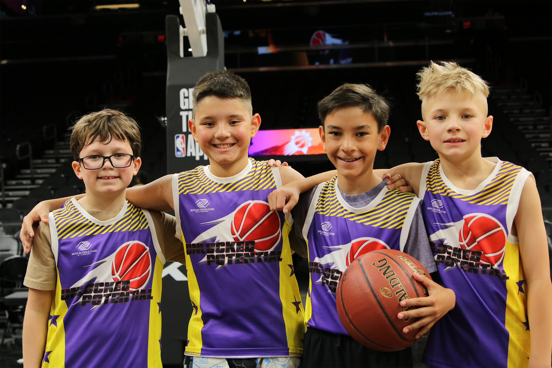 A picture of a youth basketball team playing in the Unlocked Potential Flag Elite youth winter basketball league championship.