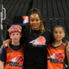 A picture of a youth basketball team playing in the Unlocked Potential Flag Elite youth winter basketball league championship with coach Kiki.