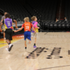 A picture of a youth basketball team playing in the Unlocked Potential Flag Elite youth winter basketball league championship at the mortgage matchup arena.