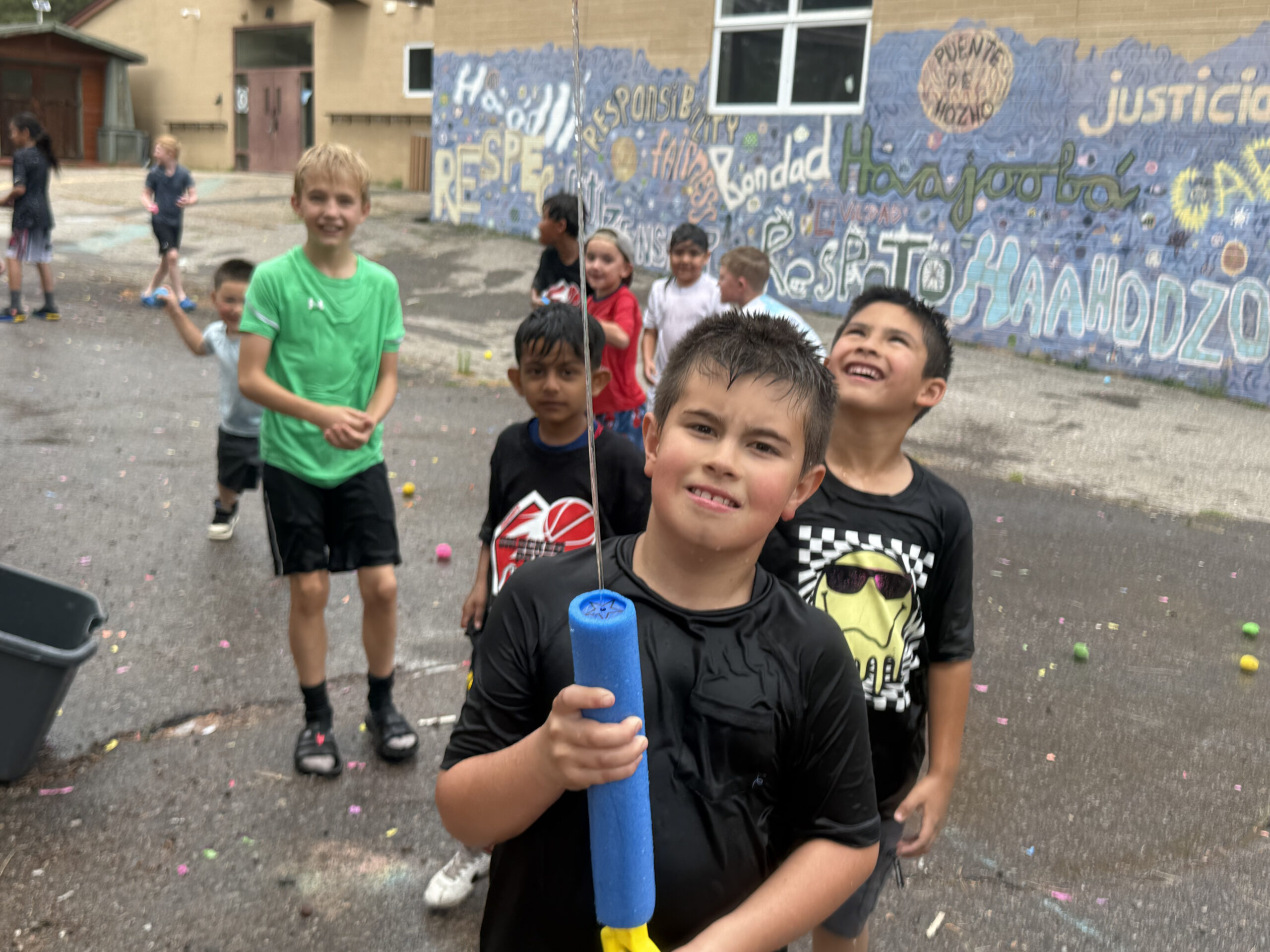 A group of kids playing with water guns at the fall break youth camp in Flagstaff, AZ.