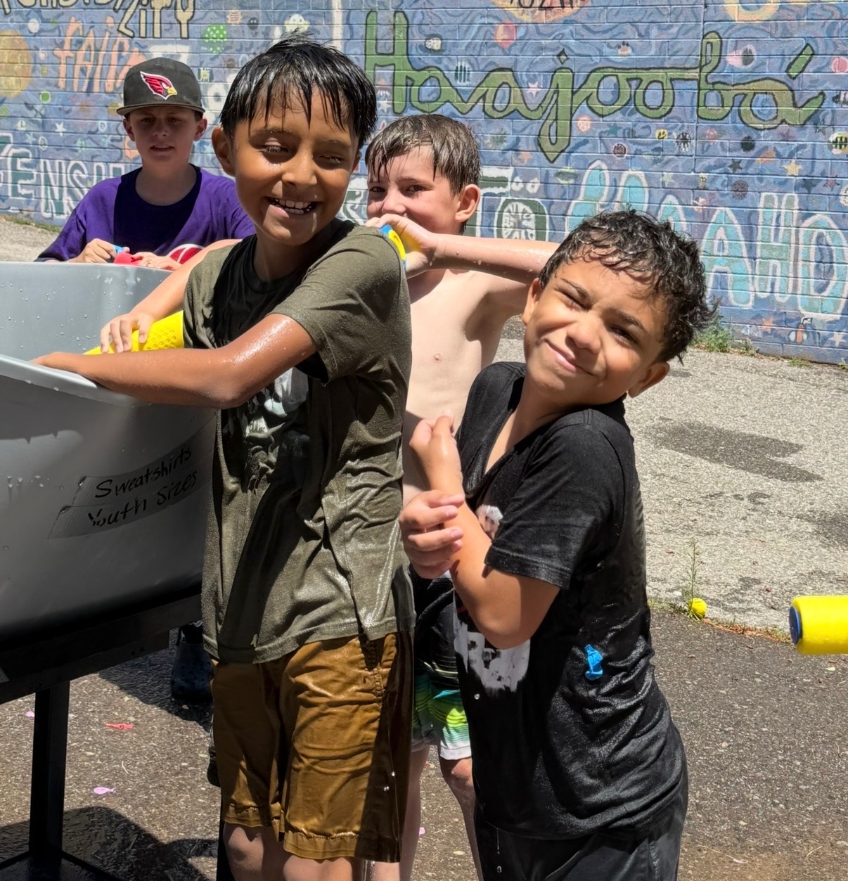 A picture of kids at unlocked potential summer youth camp in flagstaff having a water gun fight