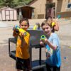 A picture of kids at unlocked potential summer youth camp in flagstaff having a water gun fight