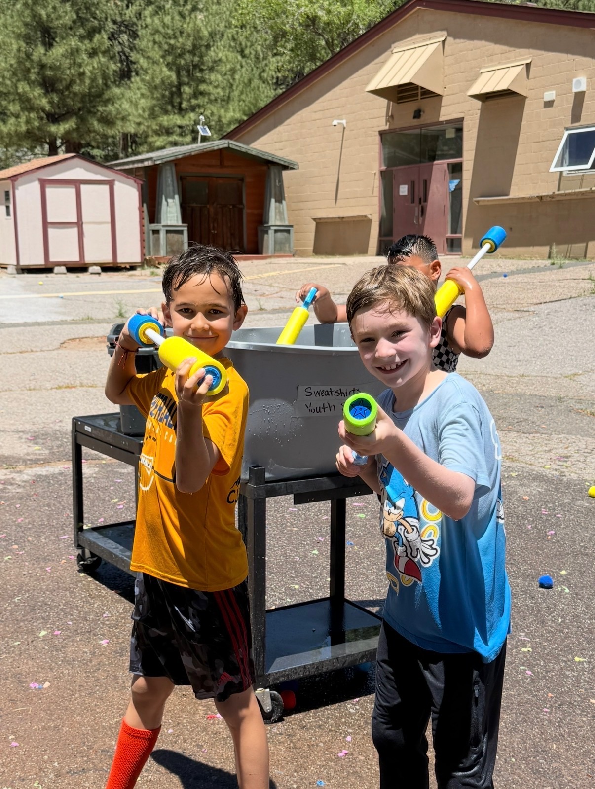 A picture of kids at unlocked potential summer youth camp in flagstaff having a water gun fight