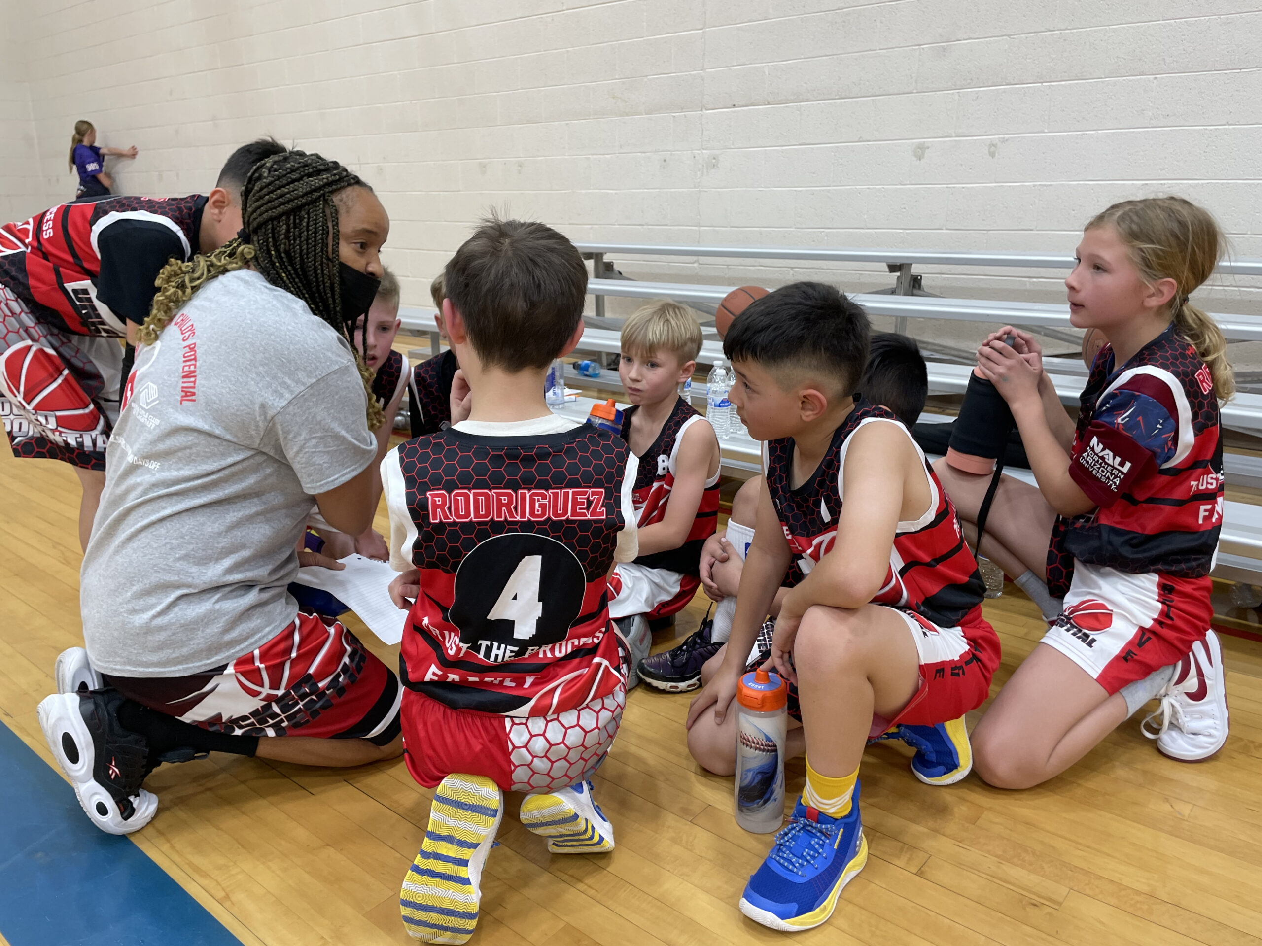 Coach Kiki coaching Unlocked Potential's youth basketball travel team