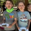 A picture of two kids eating melted bars of chocolate at the Unlocked Potential back to school fun bash camp in Flagstaff, AZ