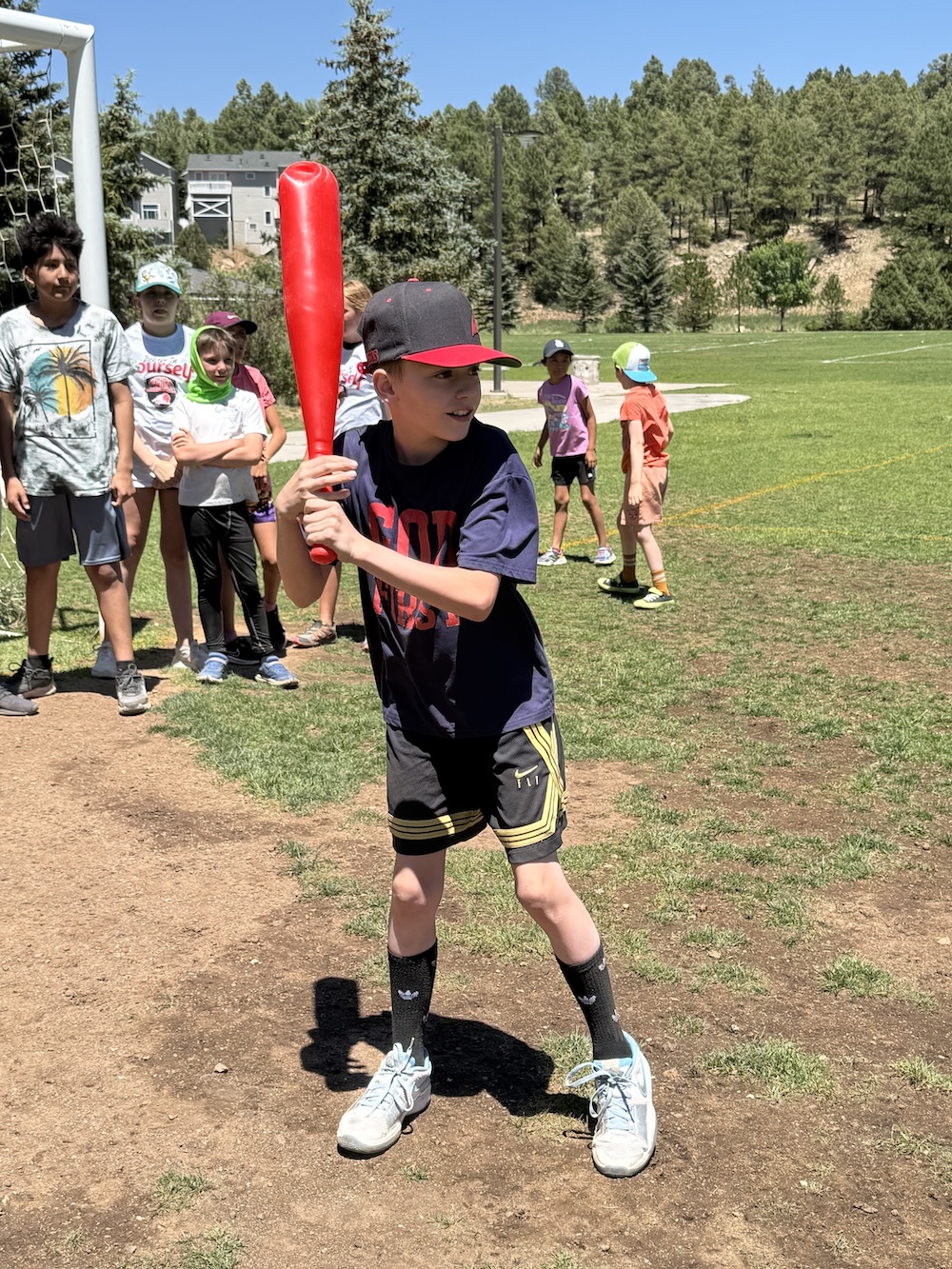 A picture of a kid playing softball at the Unlocked Potential back to school fun bash camp in Flagstaff, AZ