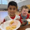 A picture of kids eating breakfast at the Unlocked Potential back to school fun bash camp in Flagstaff, AZ