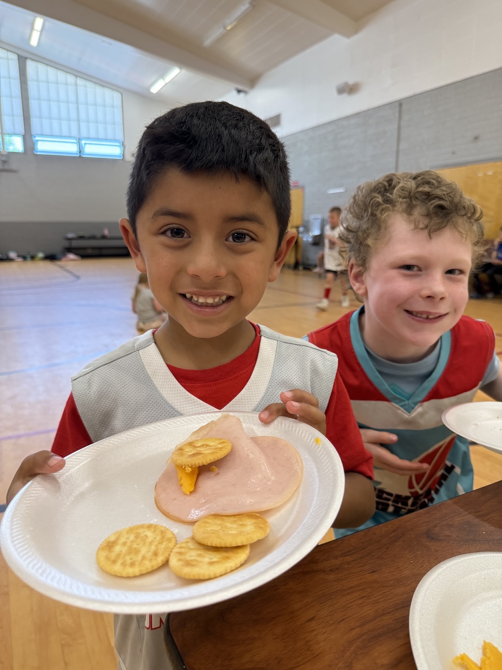 A picture of kids eating breakfast at the Unlocked Potential back to school fun bash camp in Flagstaff, AZ