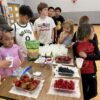 A picture of kids eating food at the Unlocked Potential back to school fun bash camp in Flagstaff, AZ